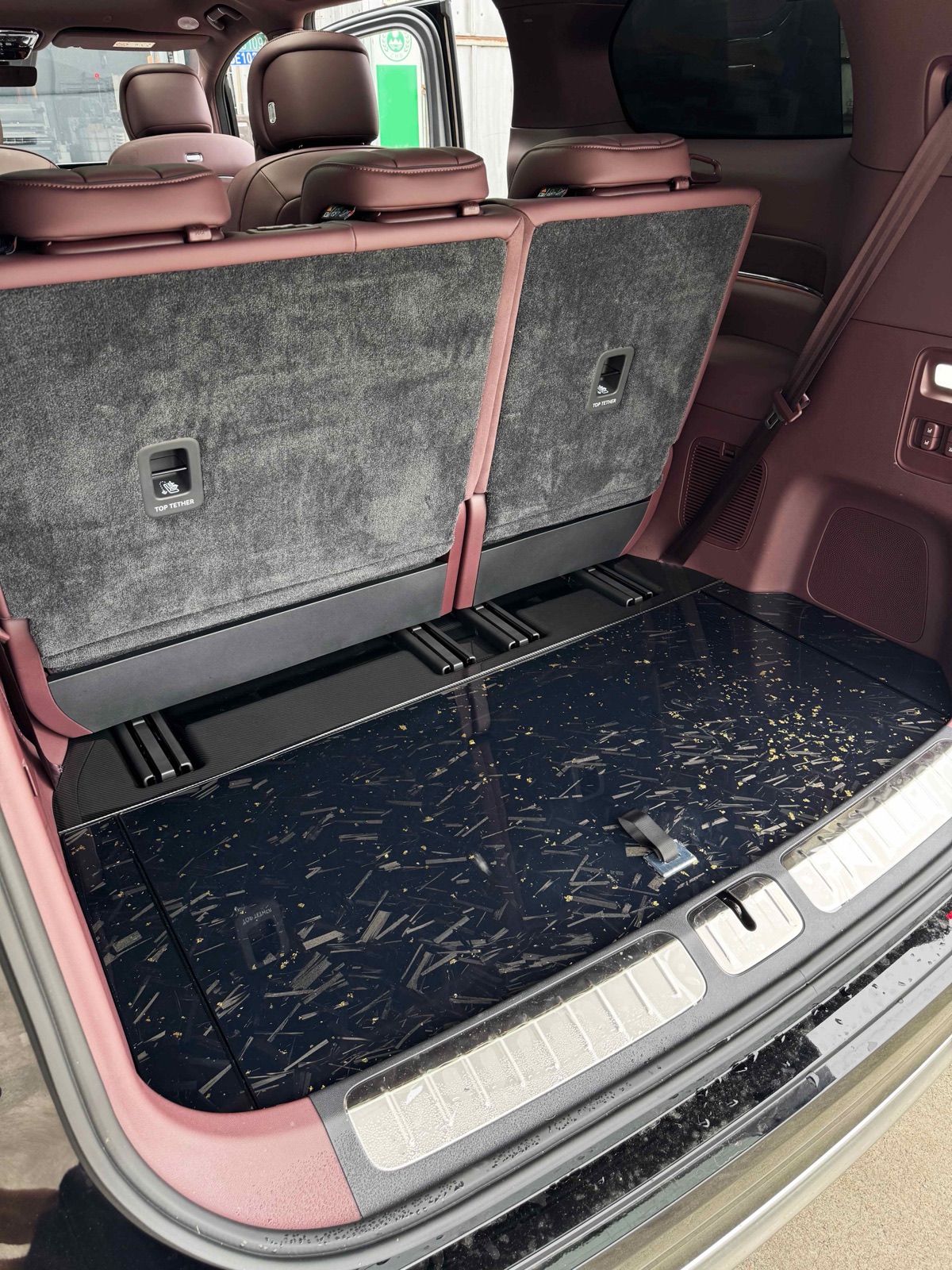 Tailgate view of a luxury MPV with a full starry black floor kit